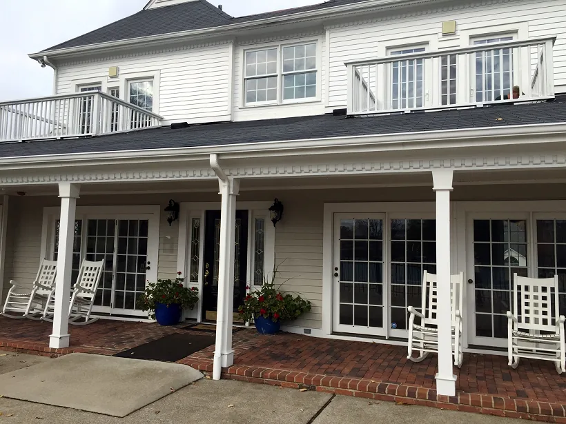 The front exterior of the Waterford clubhouse with brick facade and landscaped entry