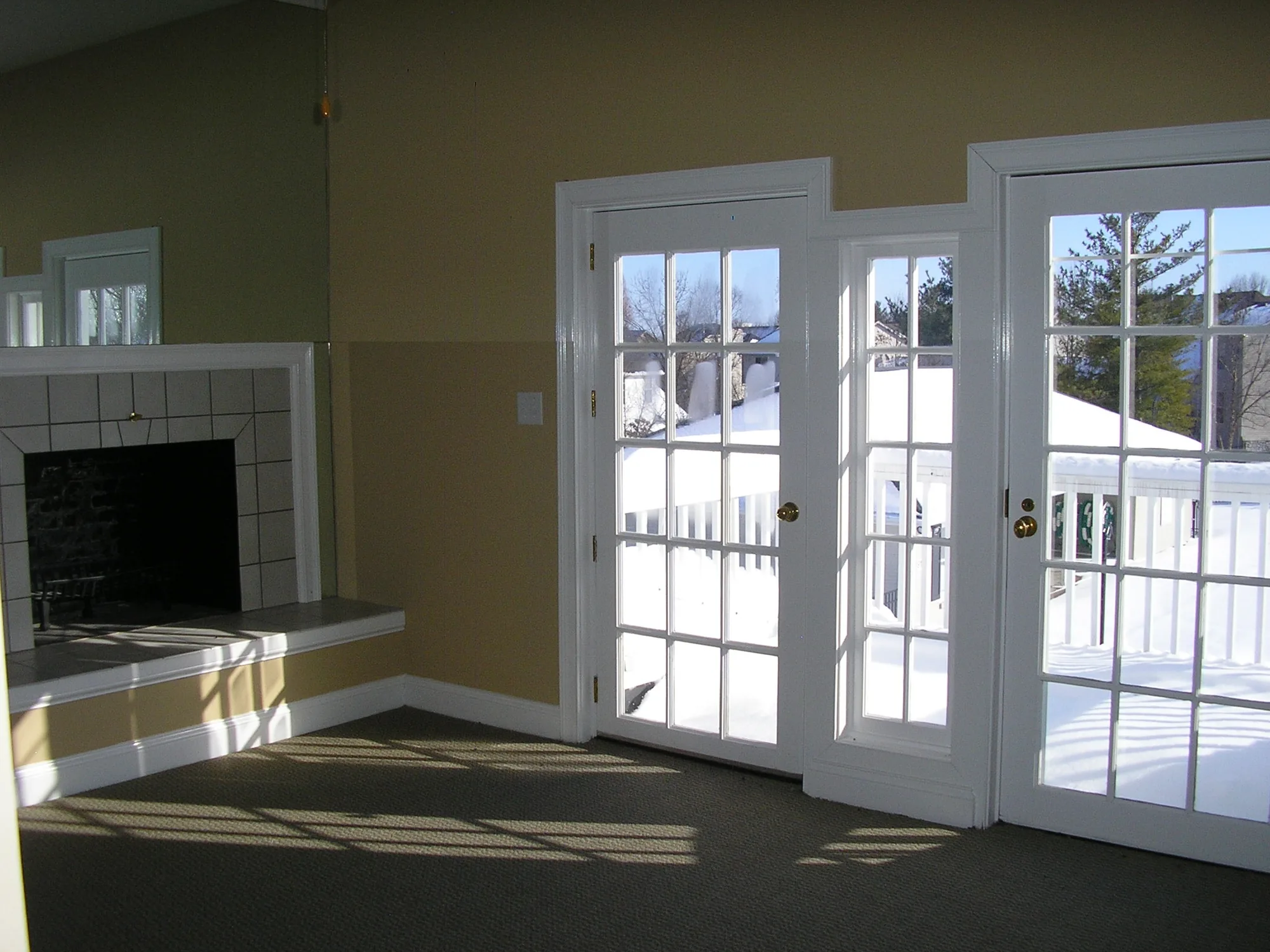 A room with french doors opening onto the pool deck