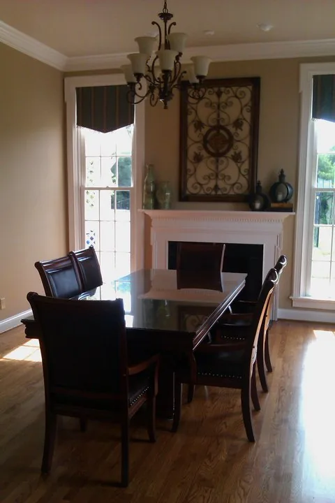 The dining room arranged for an event, with a long table and upholstered chairs